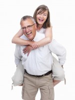 Portrait of a happy old man carrying old woman