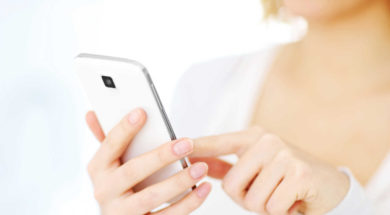 Closeup of a woman using smartphone at home